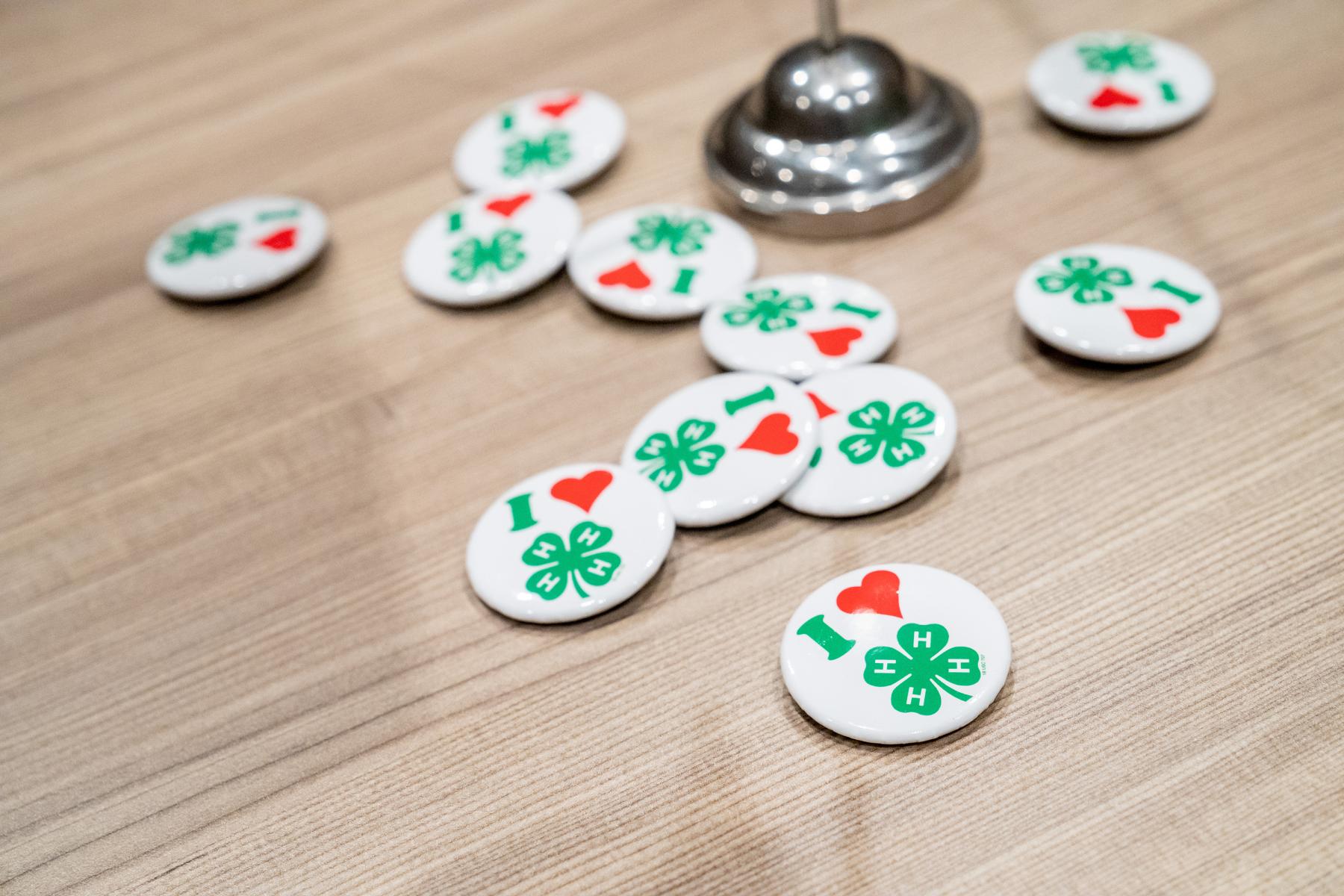 I heart 4-H buttons scattered on a tabletop