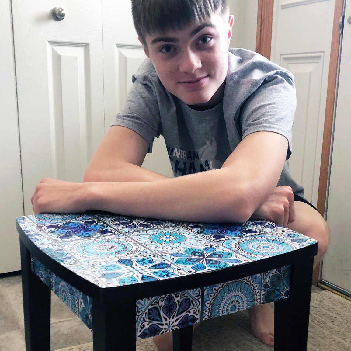 Harrison Koehn shows off the table he upcycled for a 4-H home environment project