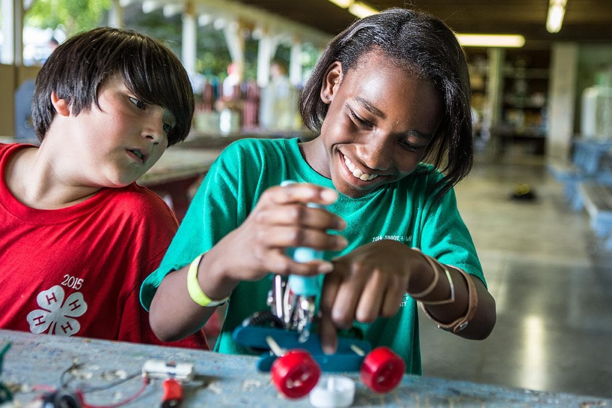 Youth working with toy cars