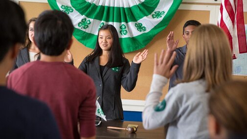 Youth saying the pledge at a club meeting