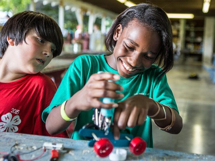 Youth working with toy cars