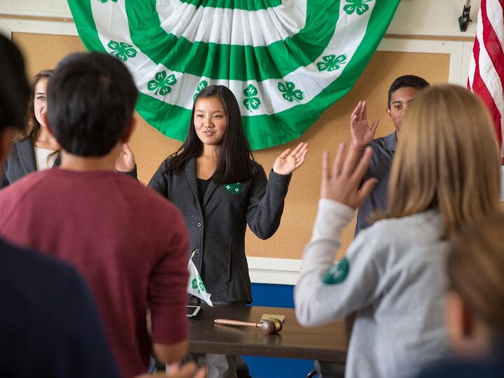 Youth saying the pledge at a club meeting