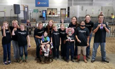 Unified Showing member pose with their ribbons after showing their lambs at the Lancaster County Fair. 