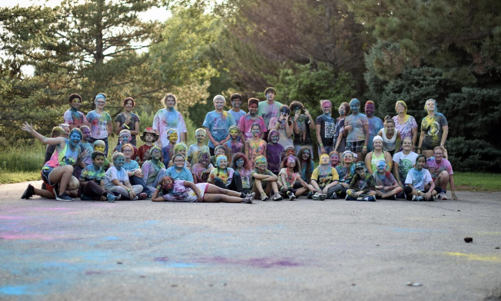 campers covered in colored powder making silly faces